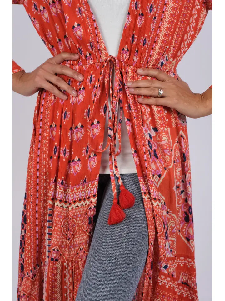 Close-up of red boho blockprint cover-up showing tie-front detail and tassel closure