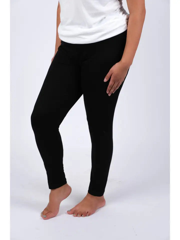 Woman wearing black spandex leggings, side view showing snug fit and full length