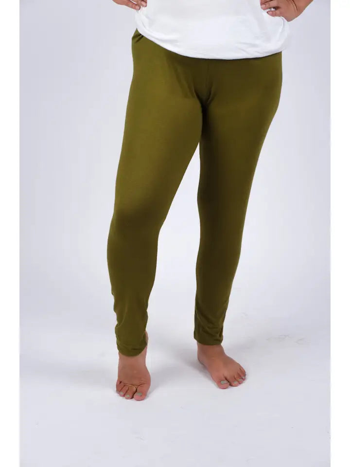 Woman wearing olive green spandex leggings, front view showing snug fit and full length