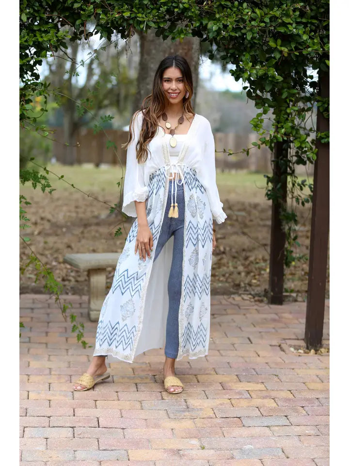 Woman wearing white Aztec boho crochet cover-up outdoors, full length lifestyle shot