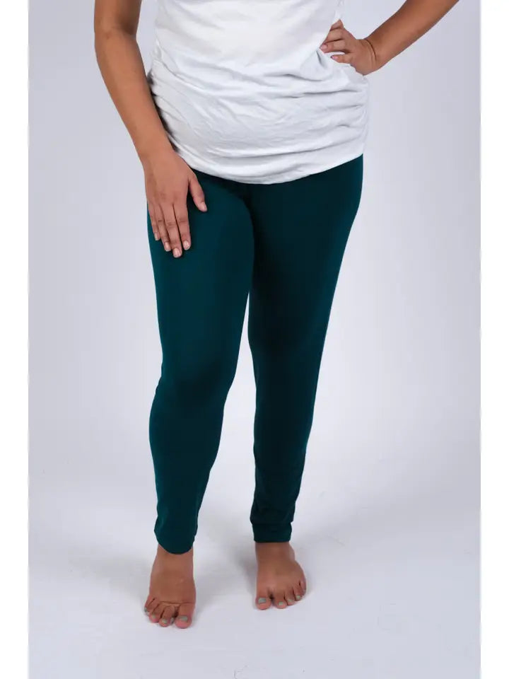 Woman wearing teal spandex leggings, front view showing snug fit and full length