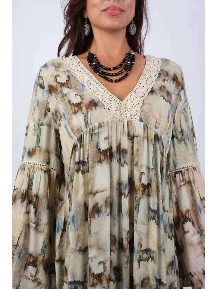Close-up of abstract camel tie-dye tunic showing lace V-neckline trim and bell sleeve detail
