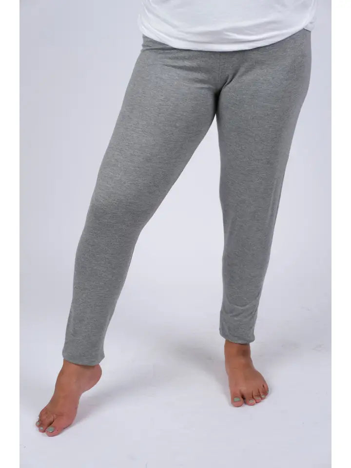 Woman wearing gray spandex leggings, front view showing snug fit and full length