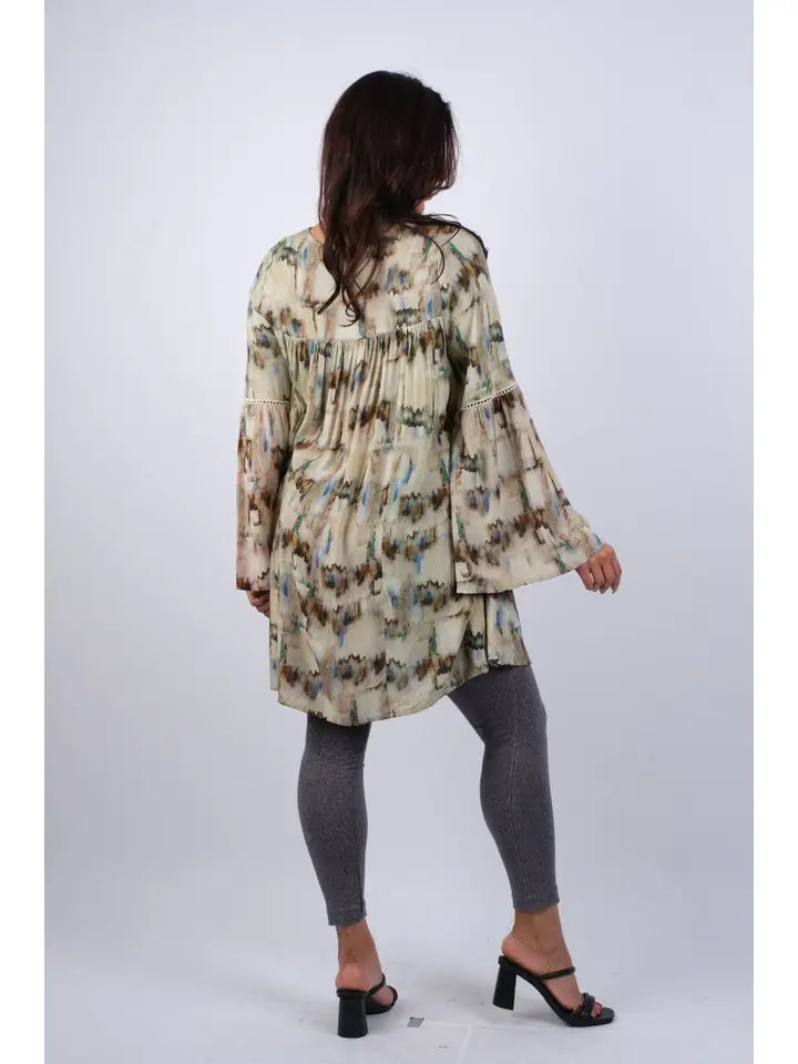 Woman wearing abstract camel tie-dye tunic with bell sleeves, back view showing full length