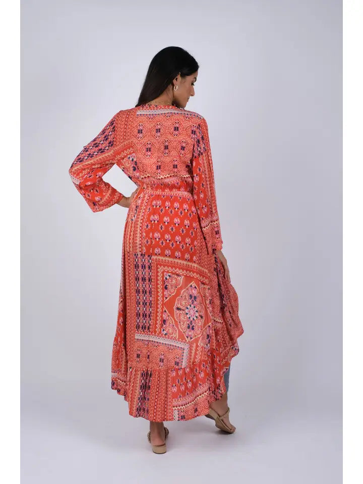 Woman wearing red boho blockprint cover-up, back view showing high-low hemline