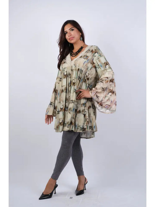 Woman wearing abstract camel tie-dye tunic with bell sleeves, side view showing relaxed fit