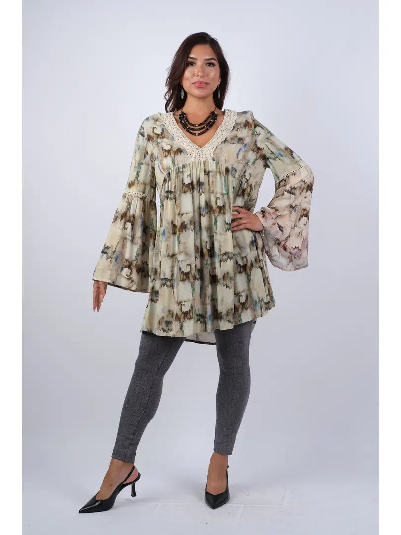 Woman wearing abstract camel tie-dye rayon tunic with bell sleeves and lace V-neckline, front view