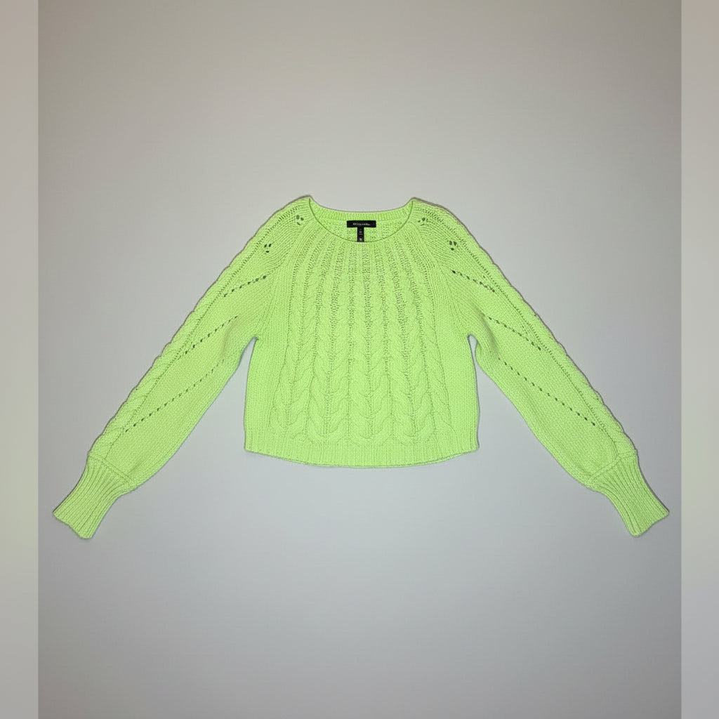 A neon yellow-green cable-knit long-sleeve sweater displayed on a black mannequin torso against a light gray wood-plank backdrop.