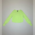 A neon yellow-green cable-knit long-sleeve sweater displayed on a black mannequin torso against a light gray wood-plank backdrop.