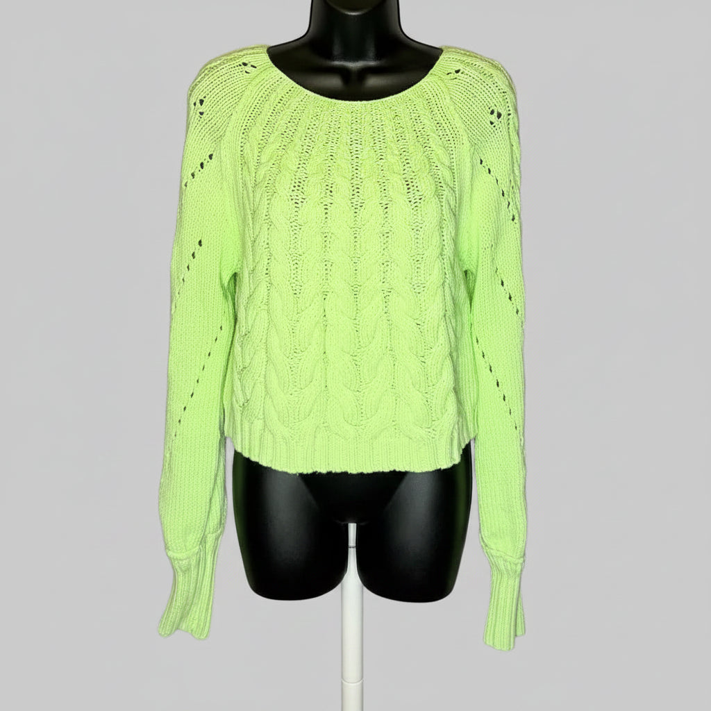Neon green sweater on a mannequin against a gray background