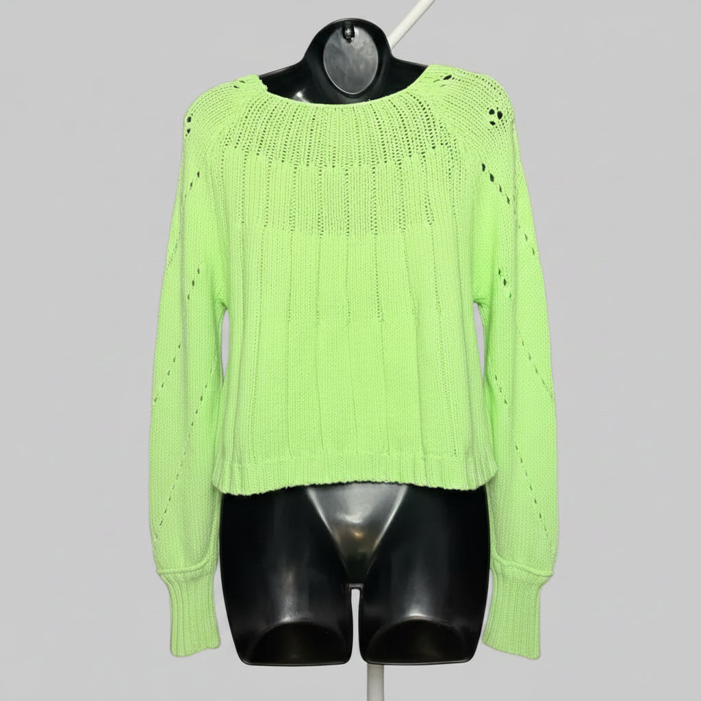 Neon green sweater on a mannequin against a gray background