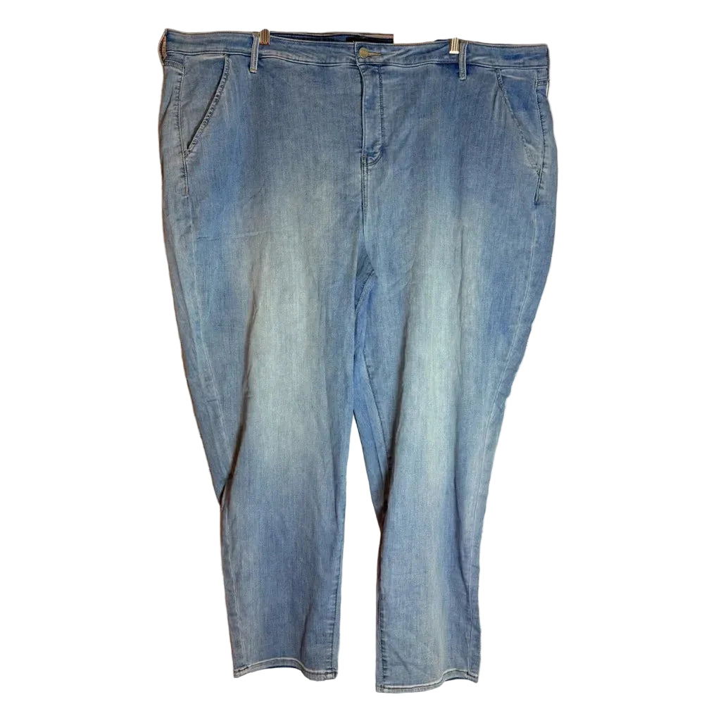 Pair of blue jeans hanging on a wooden rack against a wooden panel background