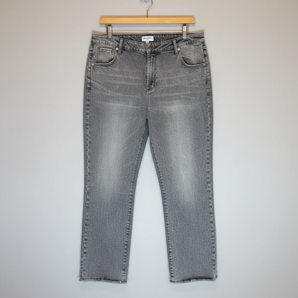 Pair of gray acid-wash jeans on a wooden surface