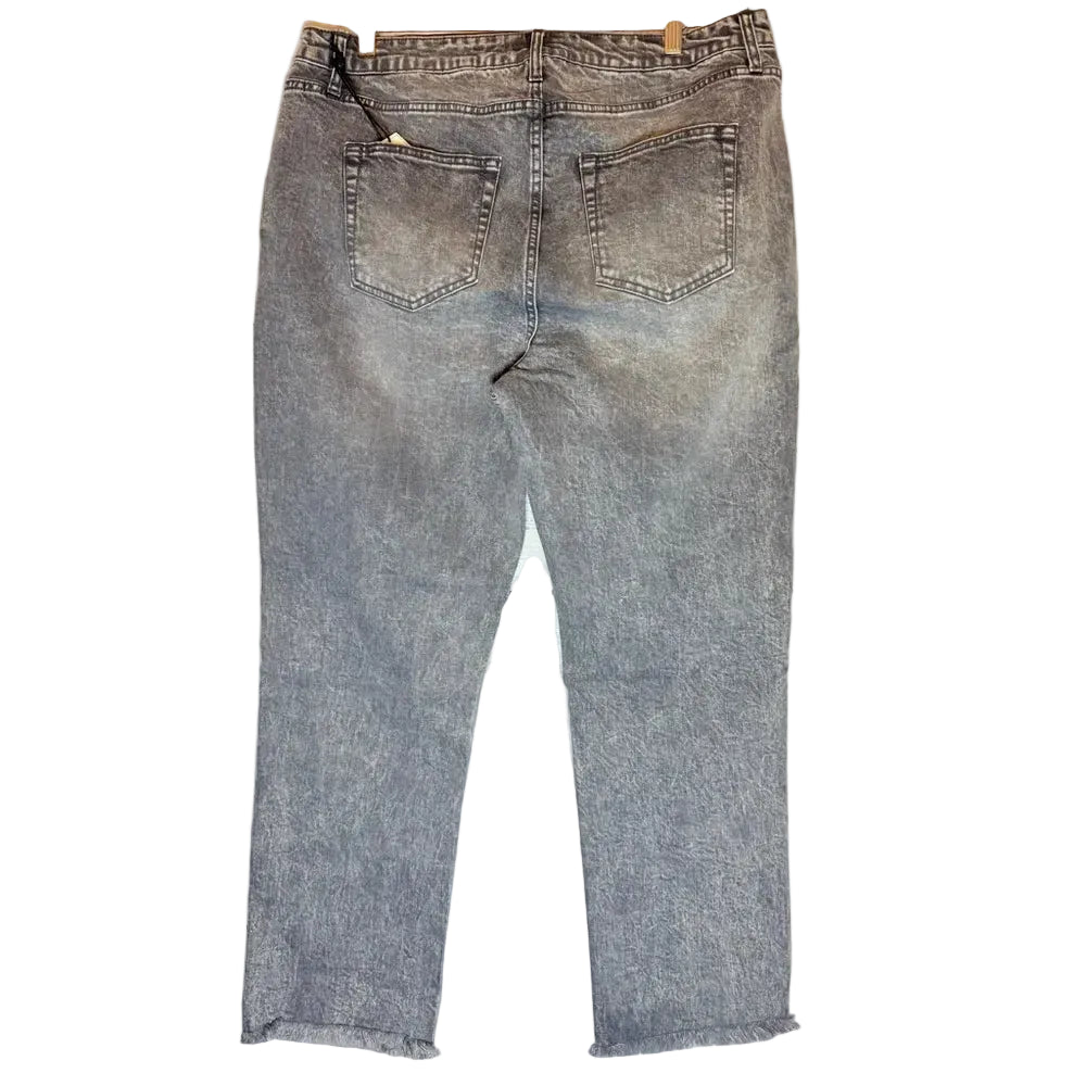 Pair of gray jeans hanging against a wooden background