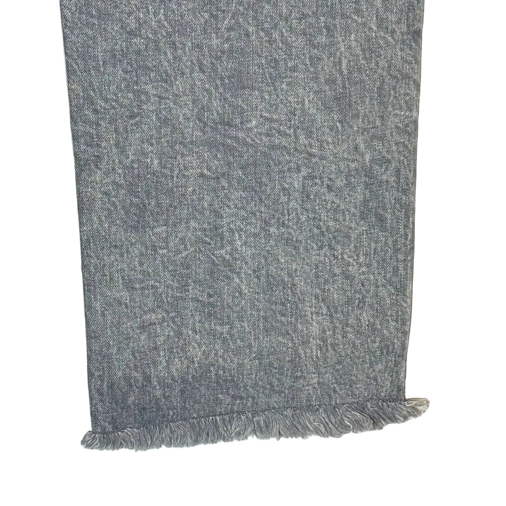 Gray scarf with frayed edges on a wooden surface