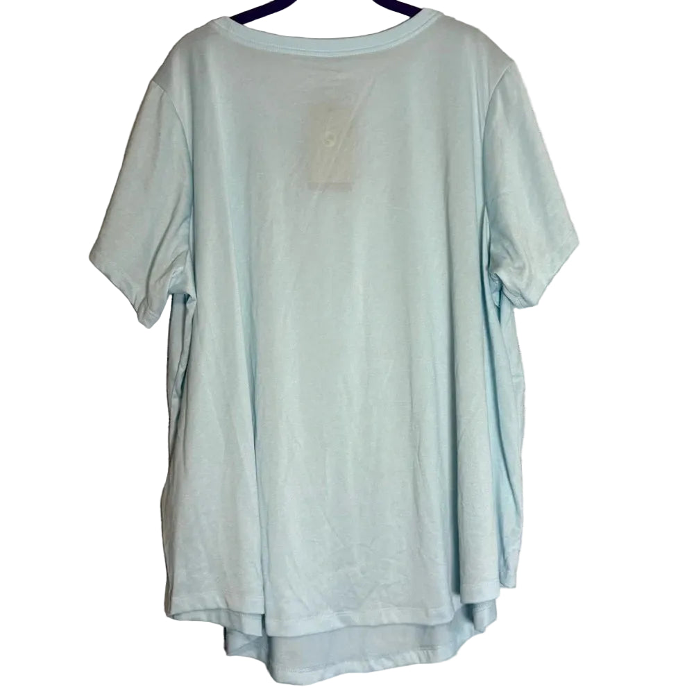 A light mint green short-sleeve t-shirt hanging on a dark hanger against a rustic whitewashed wooden plank background.