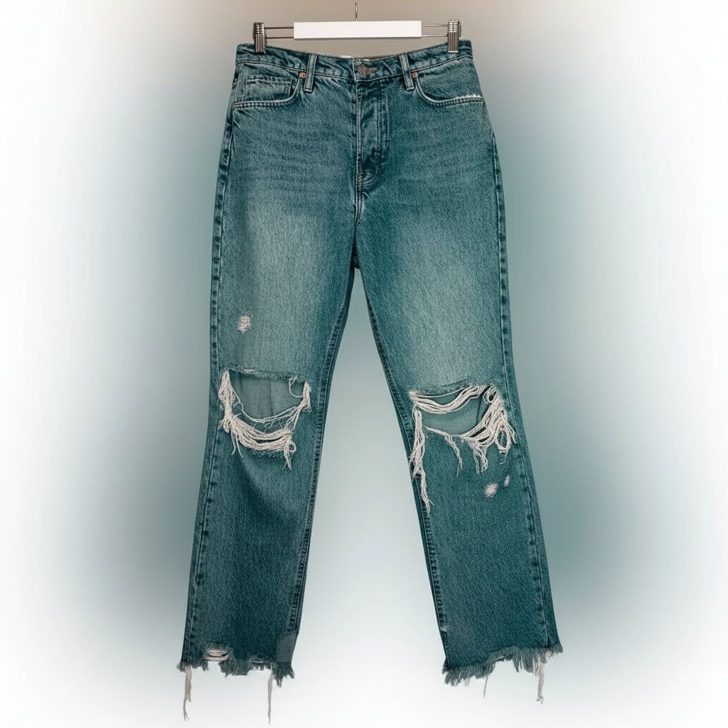 Distressed blue jeans on a white background