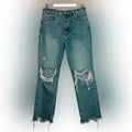 Distressed blue jeans on a white background