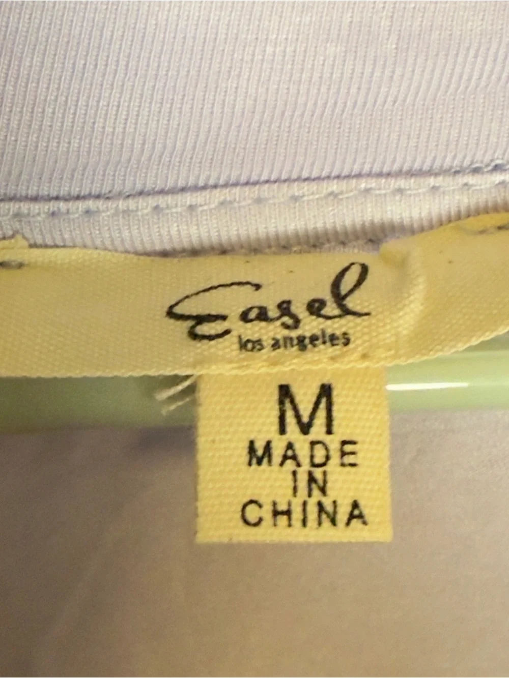 Label with 'Easel Los Angeles' and 'Made in China' text on a fabric background