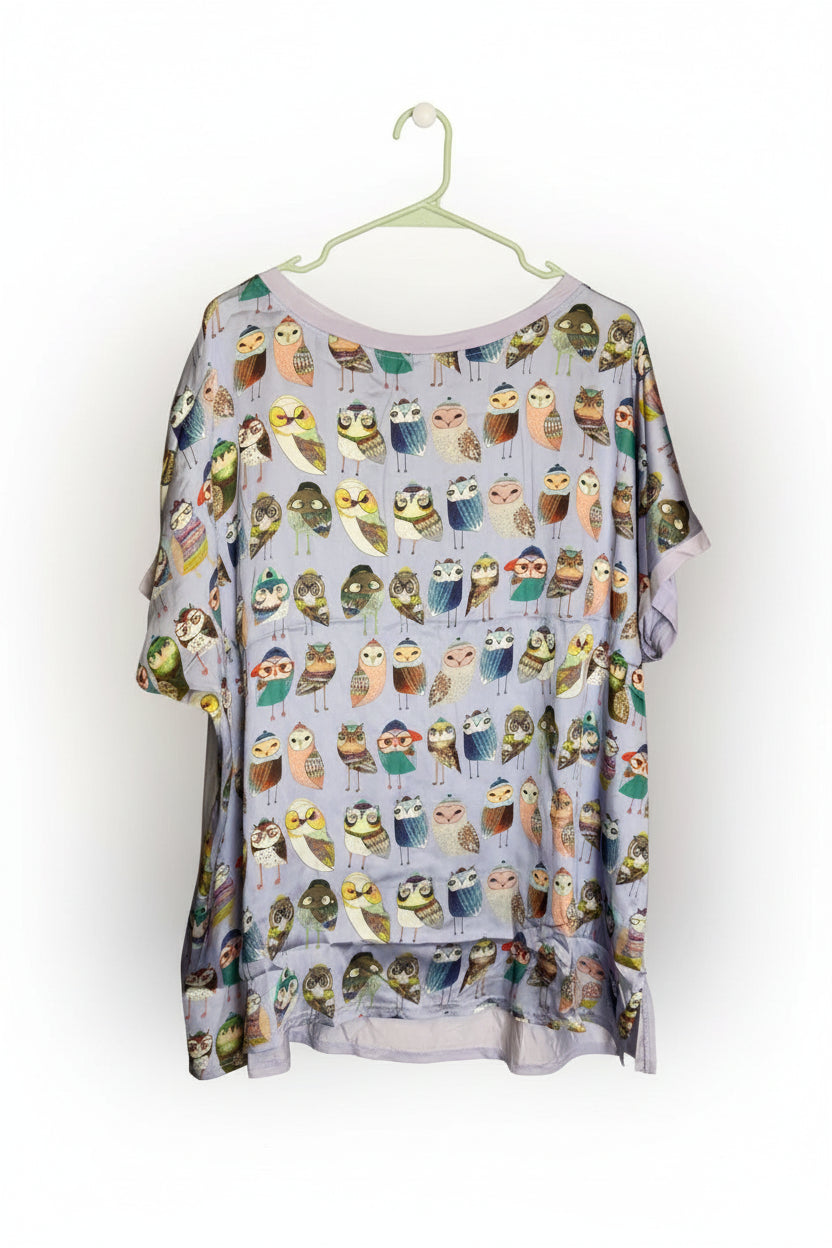 Loose-fitting shirt with owl pattern on a white background