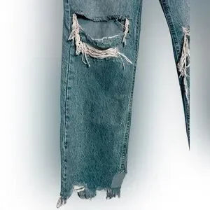 Distressed blue jeans on a white background