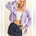 Model wearing HYFVE lilac tie cuff jacket smiling